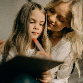 elementary school student sitting with mother